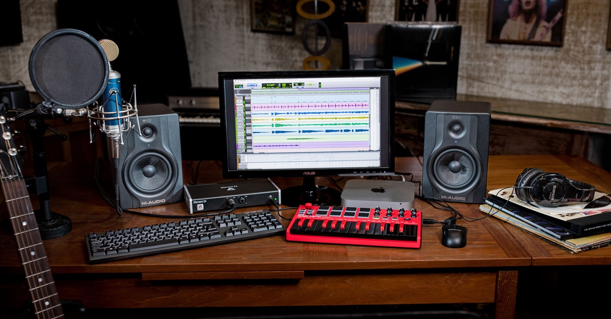 Professional music production setup with midi keyboard, monitor speakers,  and pc screen