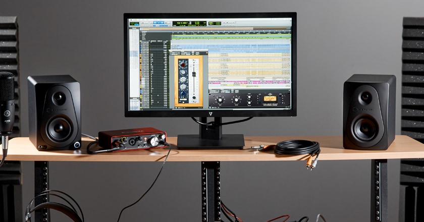 Sterling MX3 Studio Monitors on a desk in a small home studio