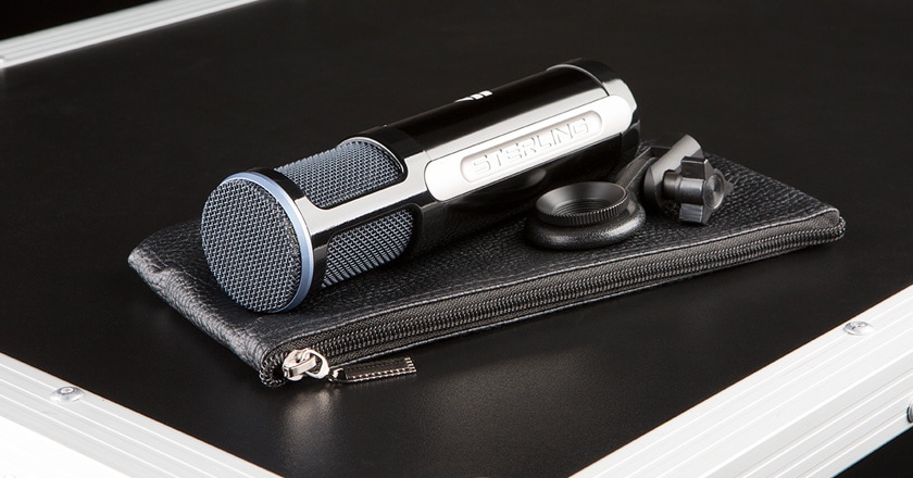 The Sterling ST151 Microphone Laying on its Side with its Leather Carrying Pouch and Mic Clip