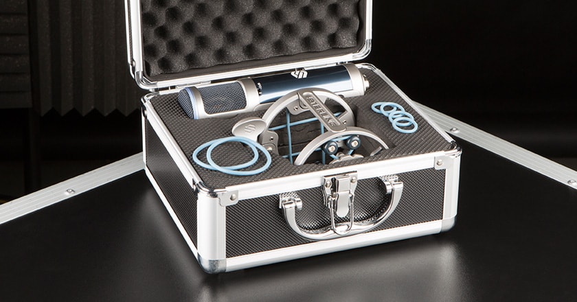 A Close-up Image of the Sterling ST159 Microphone with its Mic Clip on Top of the Included Carry Case