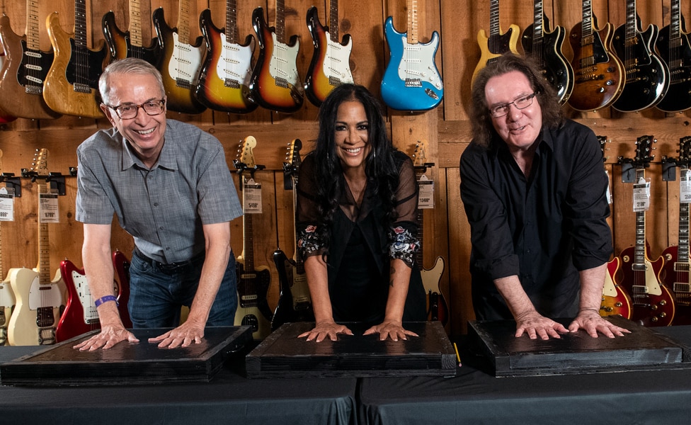 Don Lombardi, Sheila E. and John Good making handprints for Guitar Center's Rockwalk