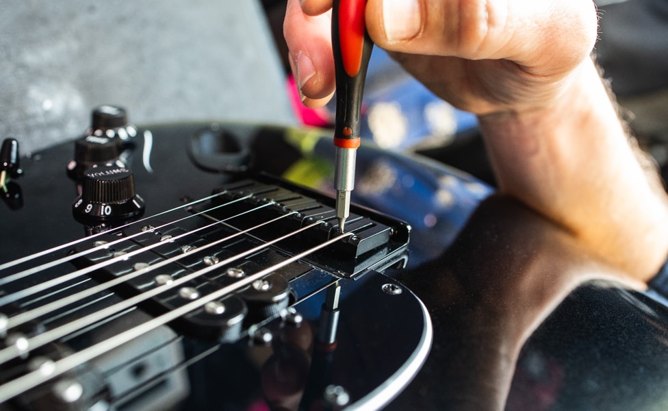 Adjusting string saddles on a Fender Stratocaster