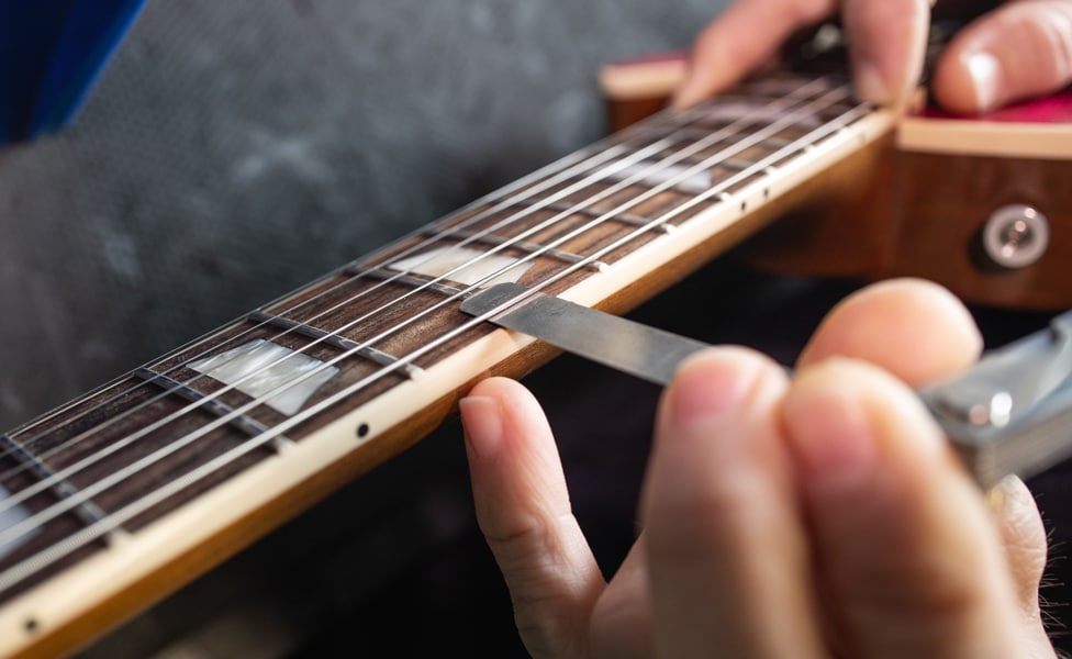 Checking string height for neck relief