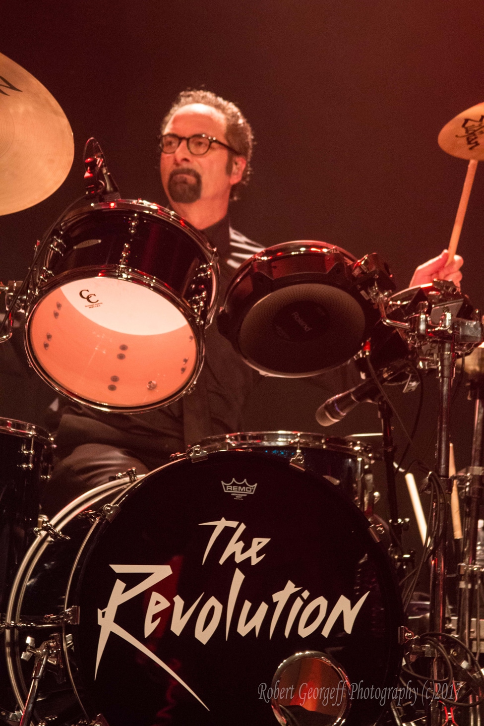 Bobby Z of The Revolution behind the drum kit by Robert Georgeff