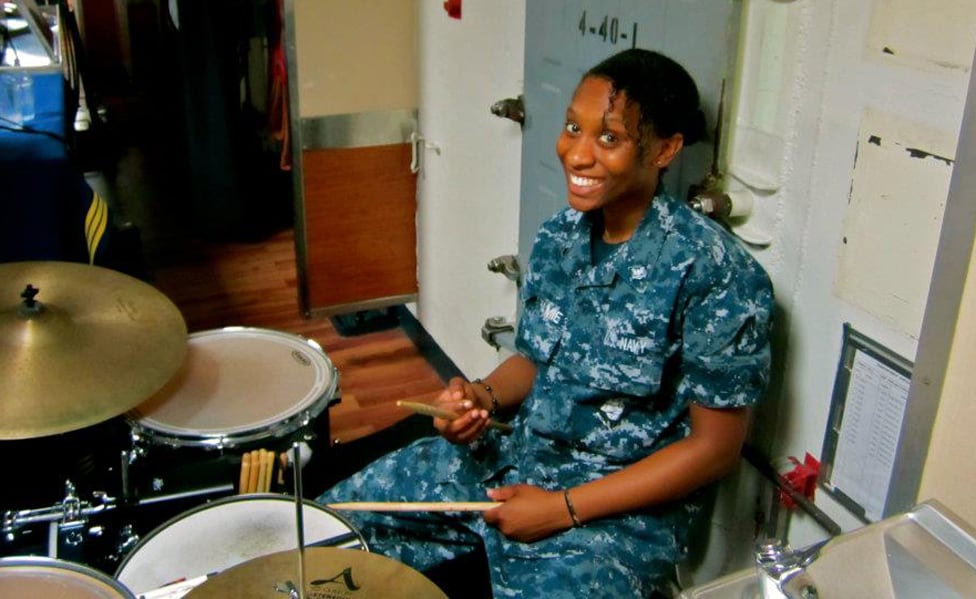 Cami Akhamie Kies drumming on a ship during her time in the Navy