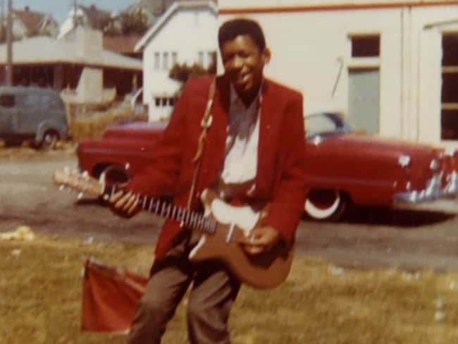 A young Jimi Hendrix plays guitar