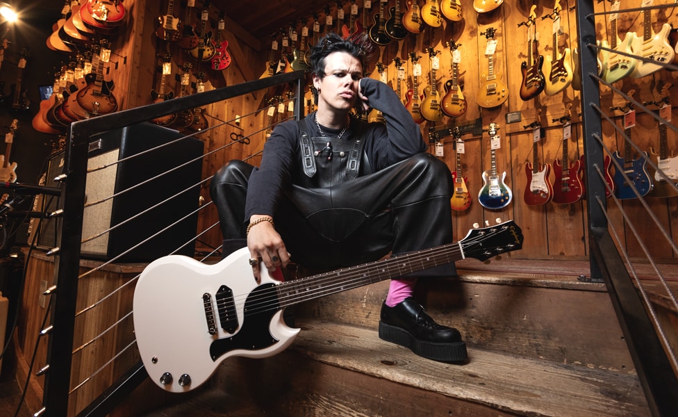 YUNGBLUD poses with his signature Epiphone SG Junior on the stairs in the Vintage Room at Guitar Center Hollywood