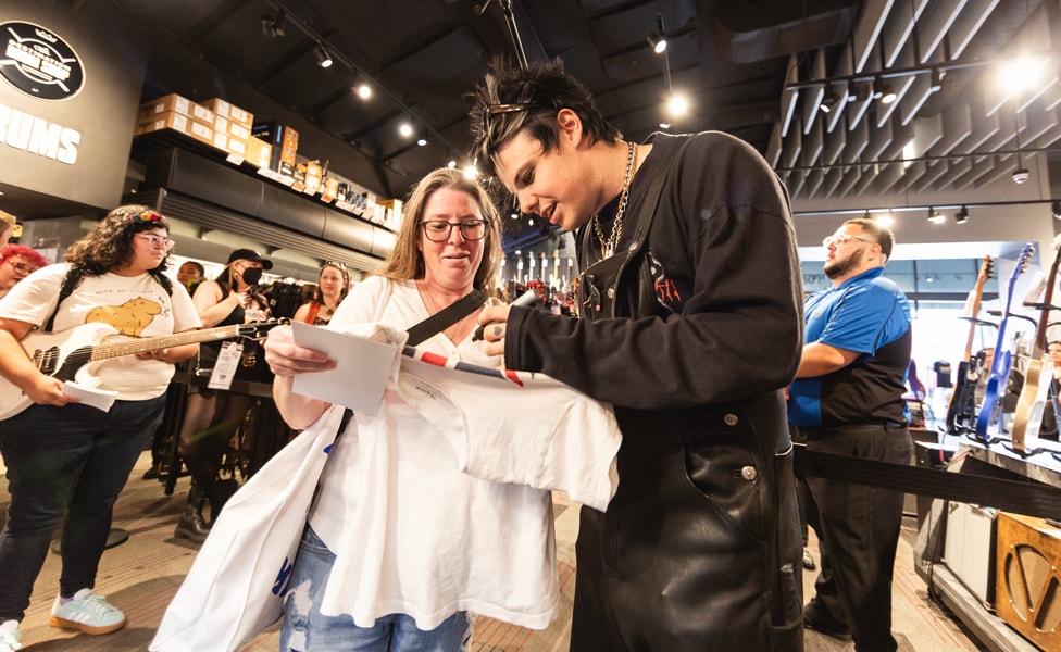 YUNGBLUD signing a shirt for a fan at Guitar Center Hollywood