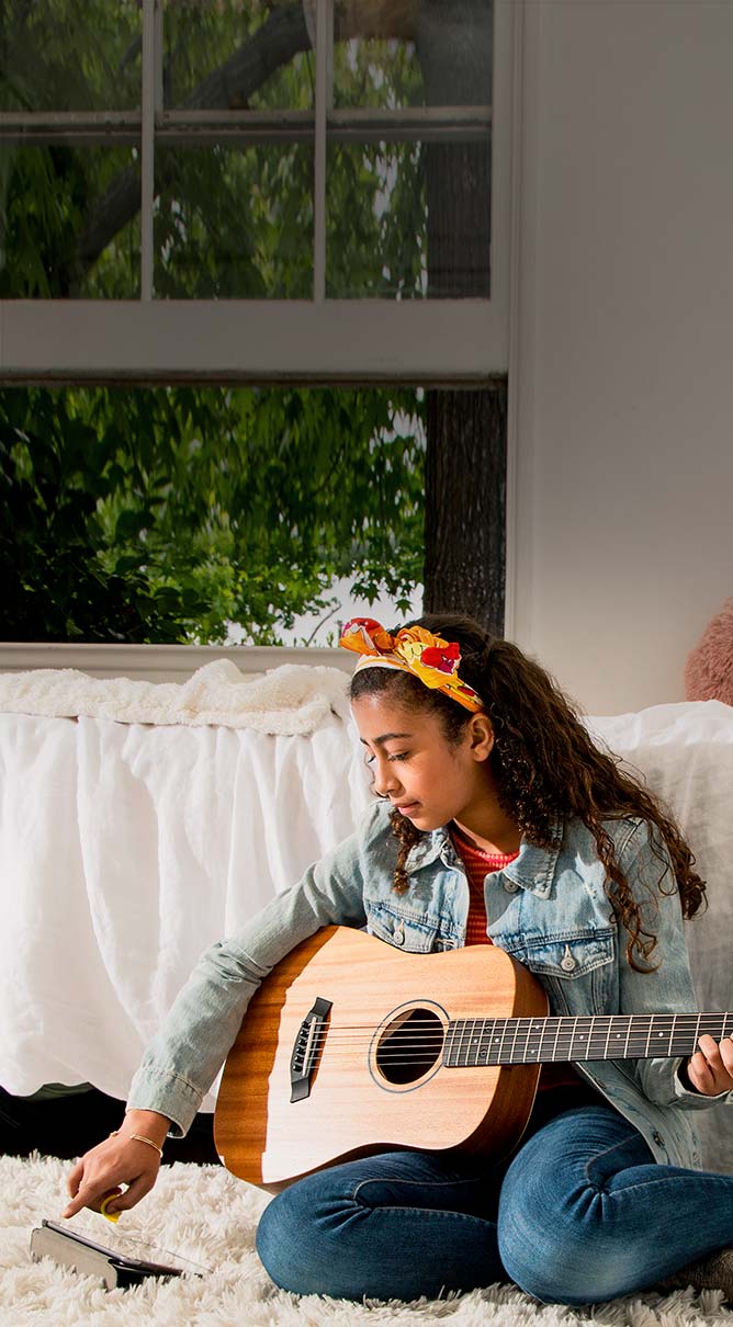Enjoy Exclusive Offers. Teenage girl playing acoustic guitar.