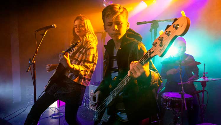 Young girl playing guitar.