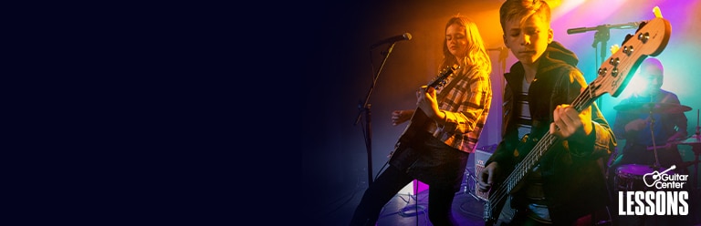 Man strumming electric guitar on stage.