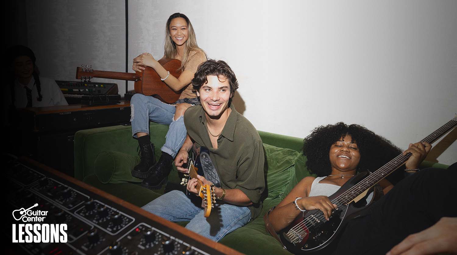 Man with beard rehearsing a song with his band.