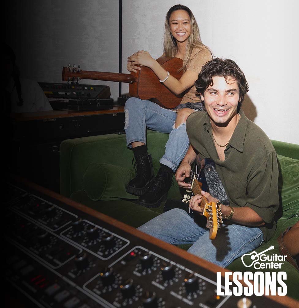 Man with beard rehearsing a song with his band.