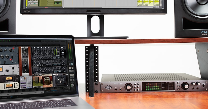Apollo x8p rackmounted on a desk with UAD plugins on a laptop screen