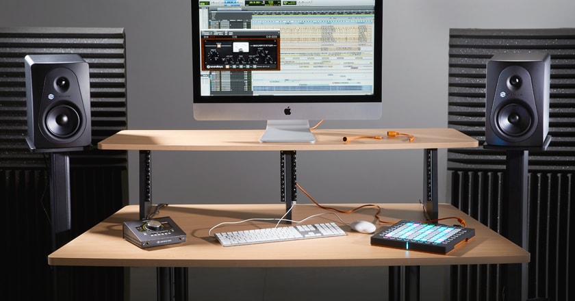 A Home Studio With Sterling MX5 Studio Monitors on Stands Beside a Desk Used for Recording and Mixing Music Music