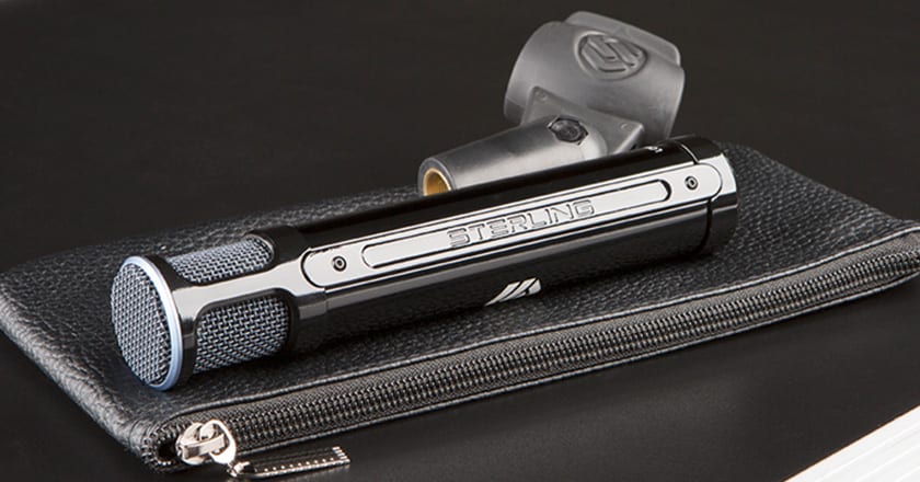 A Close-up Image of the Sterling ST131 Microphone with its Mic Clip on Top of the Included Carry Case